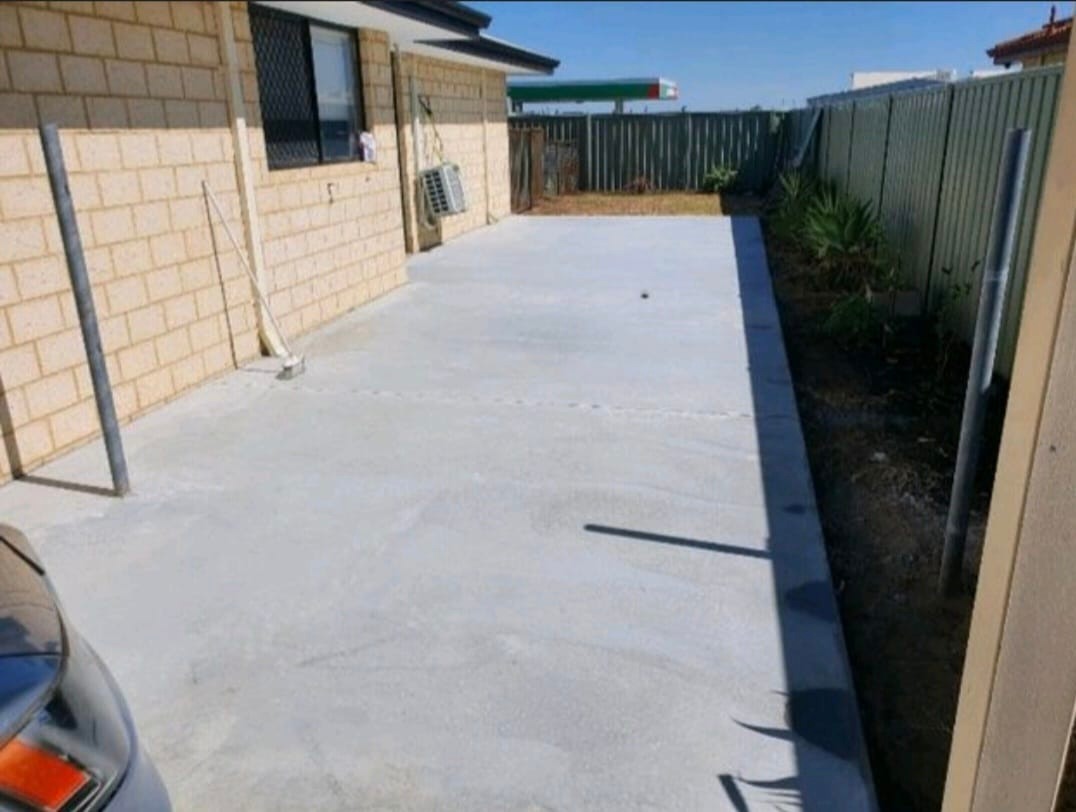 Fresh concrete driveway slab beside home in Perth